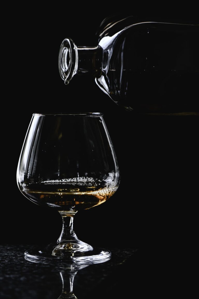 Close-Up Shot of an Alcoholic Drink Poured into a Snifter Glass